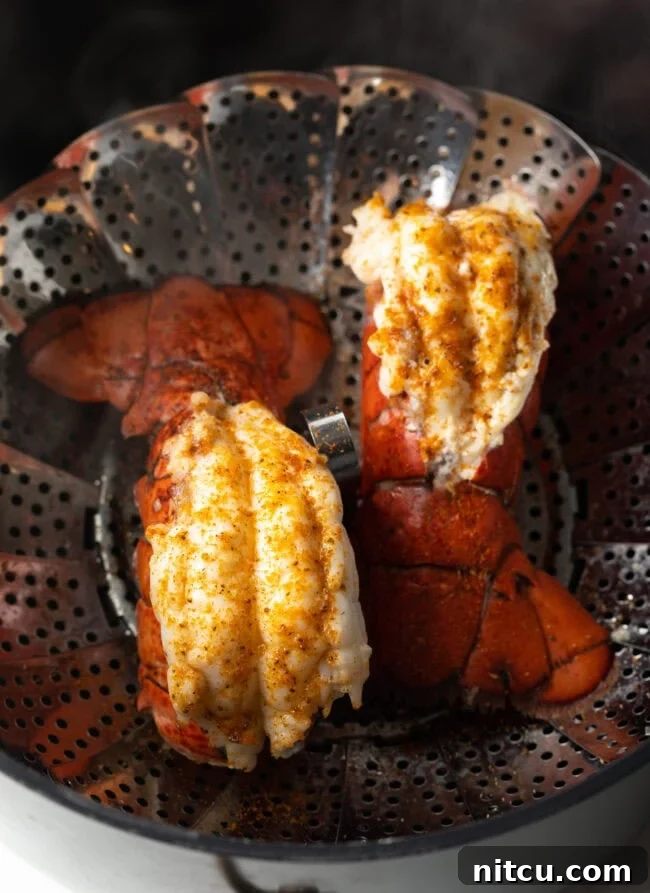 Boiling or Baking Lobster Tails Uncover the Best Method 10 Two beautifully cooked lobster tails, vibrant red and tender, resting in a steaming basket, ready to be enjoyed.