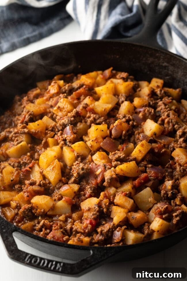 Tuscan Beef & Potato Skillet 7 Skillet with cooked ground meat and potato cubes.
