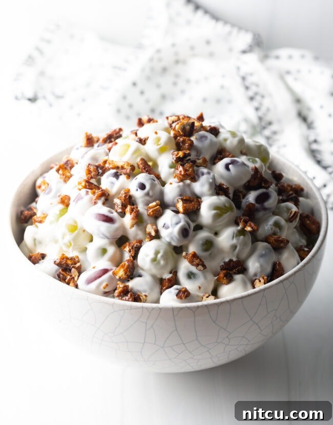 Refreshing Creamy Grape Salad 11 Side view of grape salad in a white bowl.
