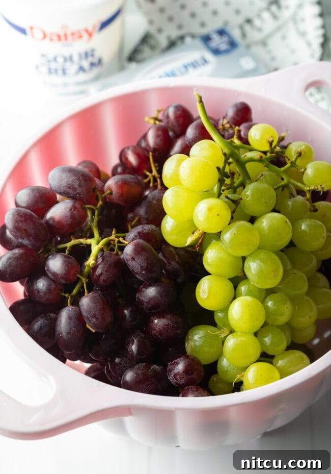 Refreshing Creamy Grape Salad 4 Green bunch and red bunch in a large white bowl.