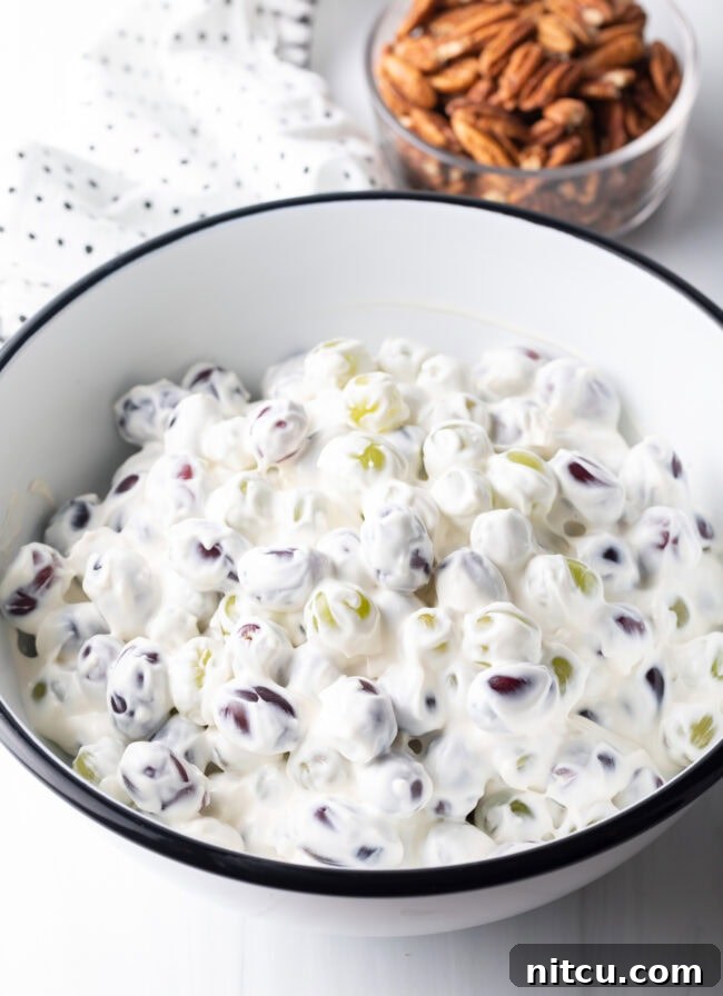 Refreshing Creamy Grape Salad 7 Everything tossed together in a white bowl.