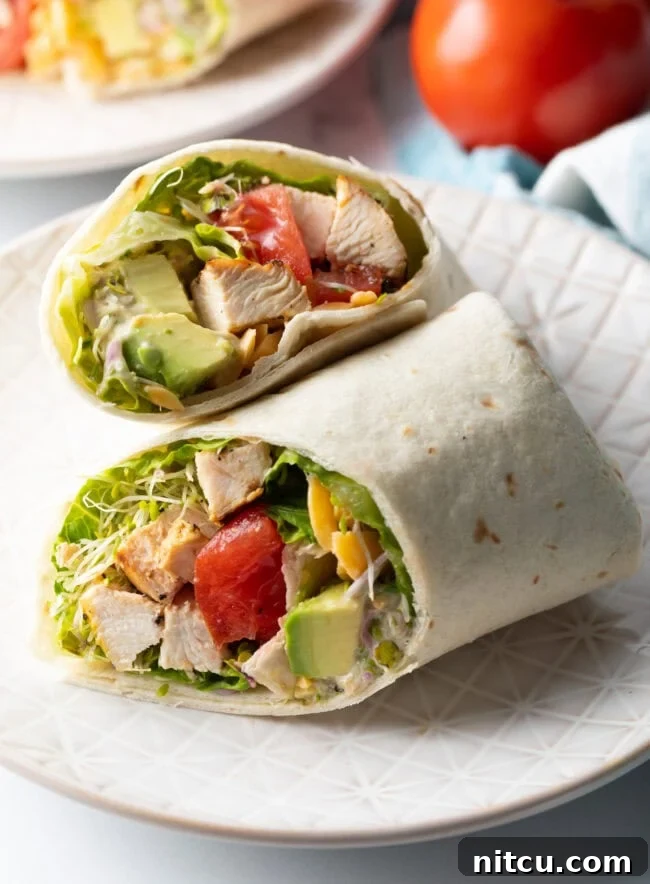 Your New Favorite Chicken Wrap 2 Top down view loaded chicken wrap, two pieces of the wrap are lying criss cross on each other.