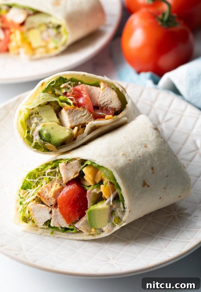 Your New Favorite Chicken Wrap 12 Top down view loaded chicken wrap, two pieces of the wrap are lying criss cross on each other.