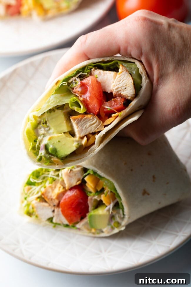 Your New Favorite Chicken Wrap 13 Hand holding chicken wrap to camera.