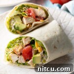 Your New Favorite Chicken Wrap 14 Top down view loaded chicken wrap, two pieces of the wrap are lying criss cross on each other.