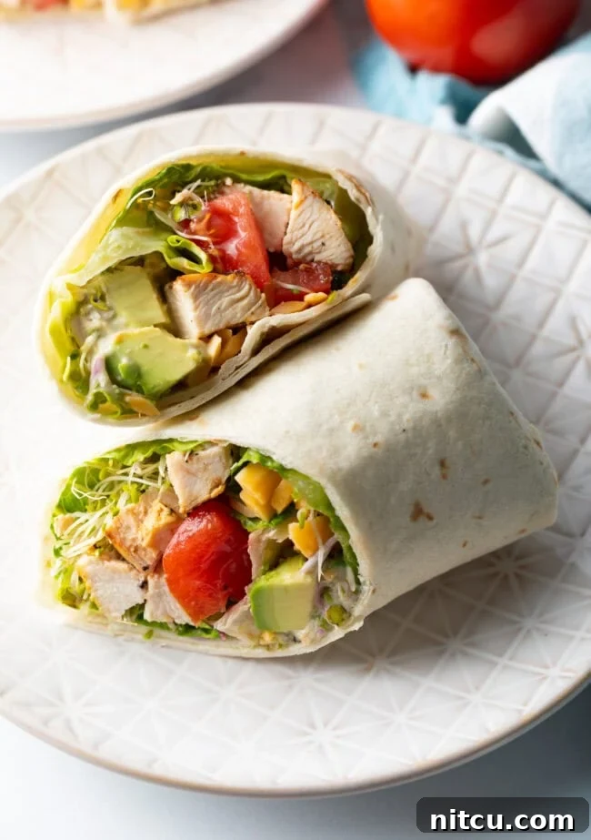 Your New Favorite Chicken Wrap 3 Top down view loaded chicken wrap, two pieces of the wrap are lying criss cross on each other.
