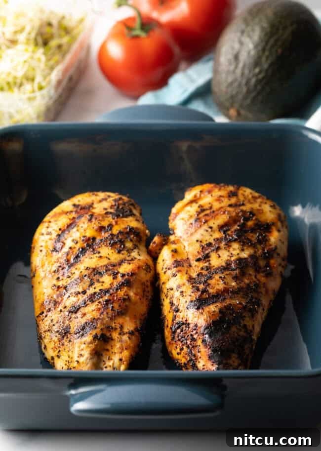 Your New Favorite Chicken Wrap 5 Two large grilled chicken breasts in a blue square baking dish.