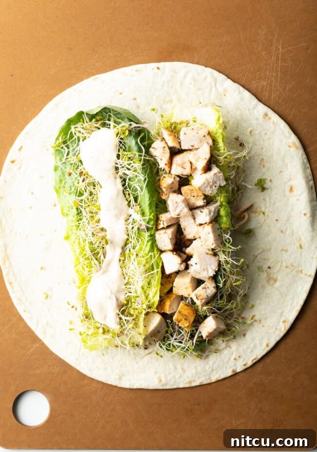 Your New Favorite Chicken Wrap 7 Tortilla flat and filled with chicken, lettuce and sprouts, dressing.