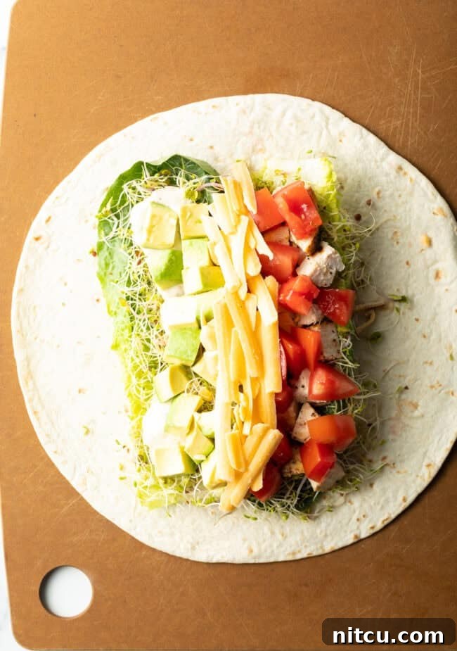 Your New Favorite Chicken Wrap 8 Tortilla filled with all of the recipe goodies.