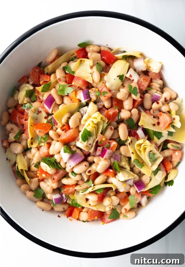 Top down view of all salad ingredients combined in a bowl.