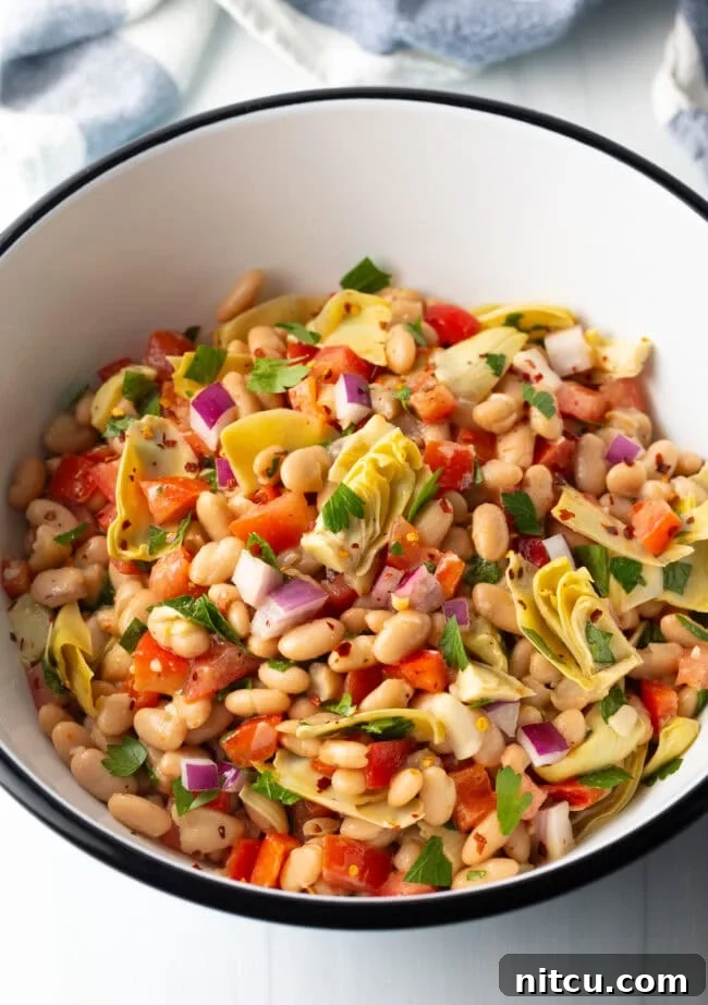 Top down view of all salad ingredients combined in a bowl.