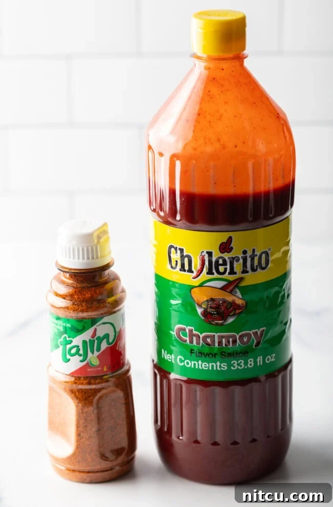 Spicy Chamoy Mexican Candies 4 Bottle of chamoy sauce and smaller bottle of Tajin seasoning, ready for mixing.