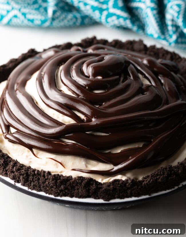 Island Sunset Pie 12 Hot fudge being spread over the frozen ice cream pie.