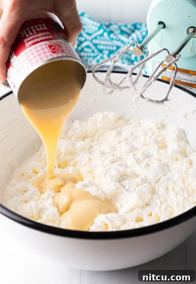 Island Sunset Pie 9 Heavy cream being whipped in a stand mixer.