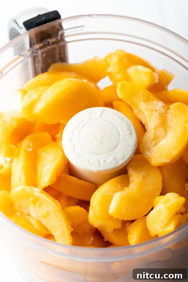 Peach slices being prepared in a food processor.