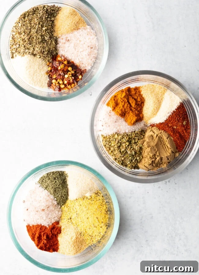 Signature Chicken Seasoning 5 Top down view three bowls, each with a different blend of chicken seasoning.