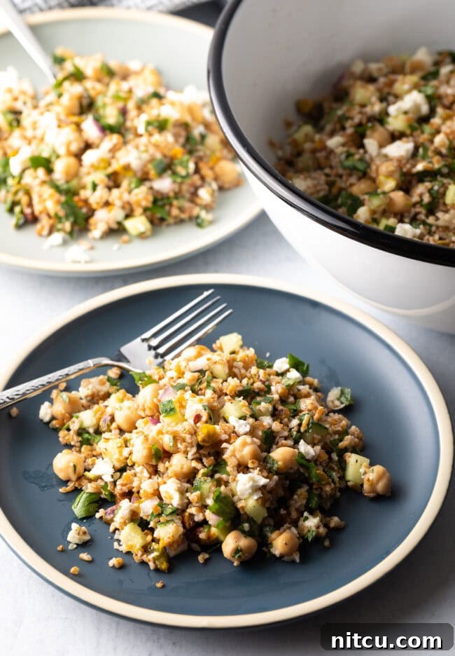 Jennifer Aniston's Go-To Bulgur Salad 14 Blue plate with a generous serving of Jennifer Aniston bulgur wheat salad, with a metal fork on the plate.