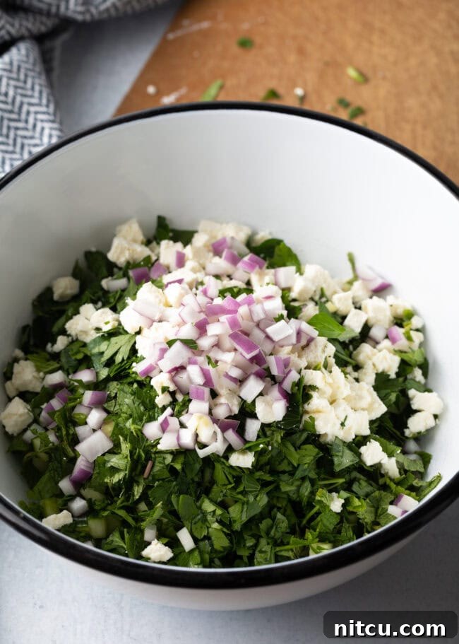 Jennifer Aniston's Go-To Bulgur Salad 7 Chopped veggies and bulgur in a large white bowl.