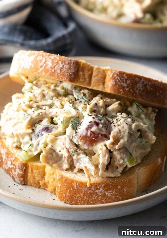 Perfect Turkey Sandwich Salad 11 Large turkey salad sandwich on a white plate. Final shot of leftover turkey recipe post.