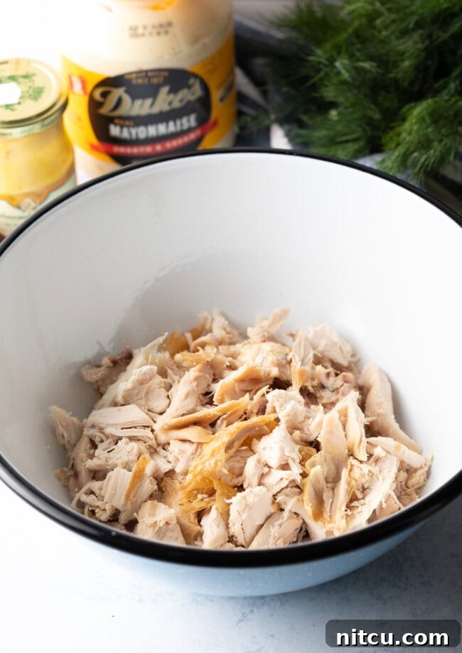 Perfect Turkey Sandwich Salad 5 Shredded leftover turkey in a white bowl.