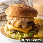Double patty stacked cheeseburger with homemade Big Mac sauce.