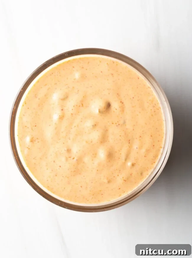 Top down view of a bowl filled with creamy, homemade Big Mac sauce, garnished slightly.