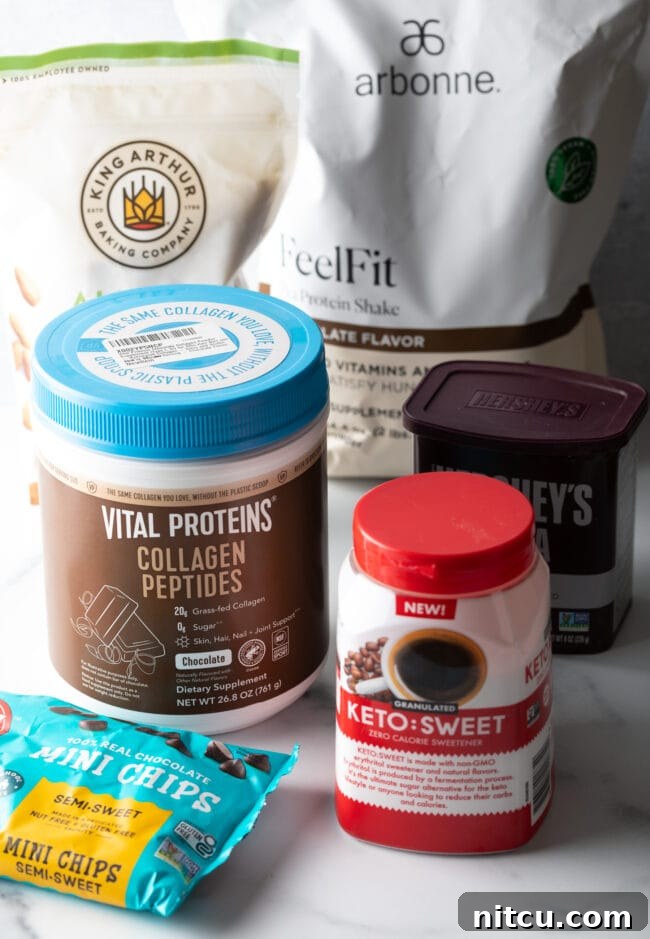 Glow-Up Protein Brownies 5 Recipe ingredients in their packages: Almond flour, erythritol sweetener, unsweetened cocoa powder, collagen peptides, and sugar-free chocolate chips, laid out neatly.