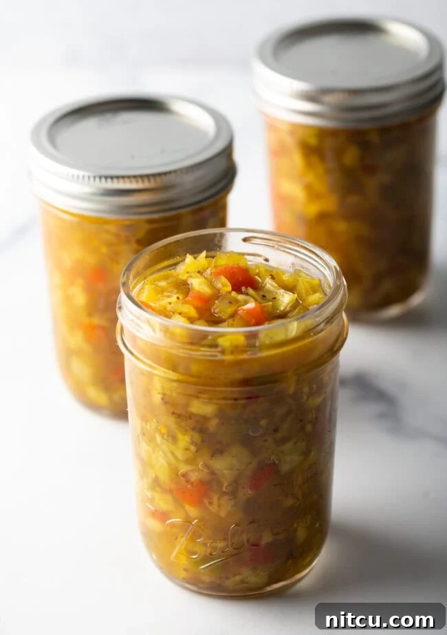 Tangy Homemade Chow Chow 11 3 glass jars of southern chow chow relish. Front jar has lid off, back two jars have metal lids on.