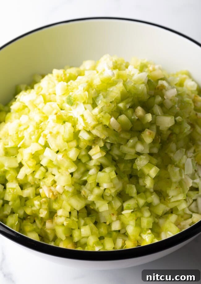 Tangy Homemade Chow Chow 5 Adding chopped tomatillos to the bowl.