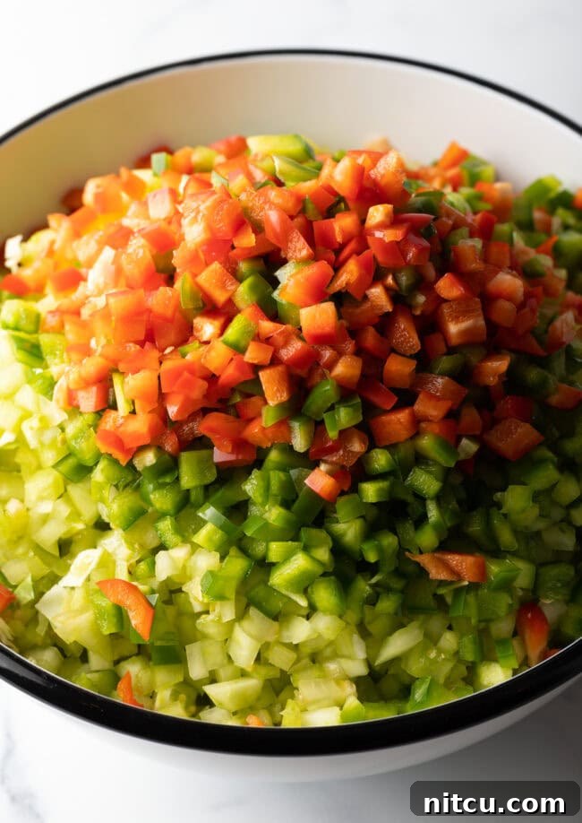 Tangy Homemade Chow Chow 6 Adding chopped bell pepper to the bowl of veggies.