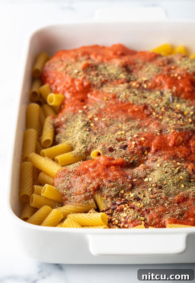 One-Pan Meatball Casserole 5 Adding herbs to the noodles.