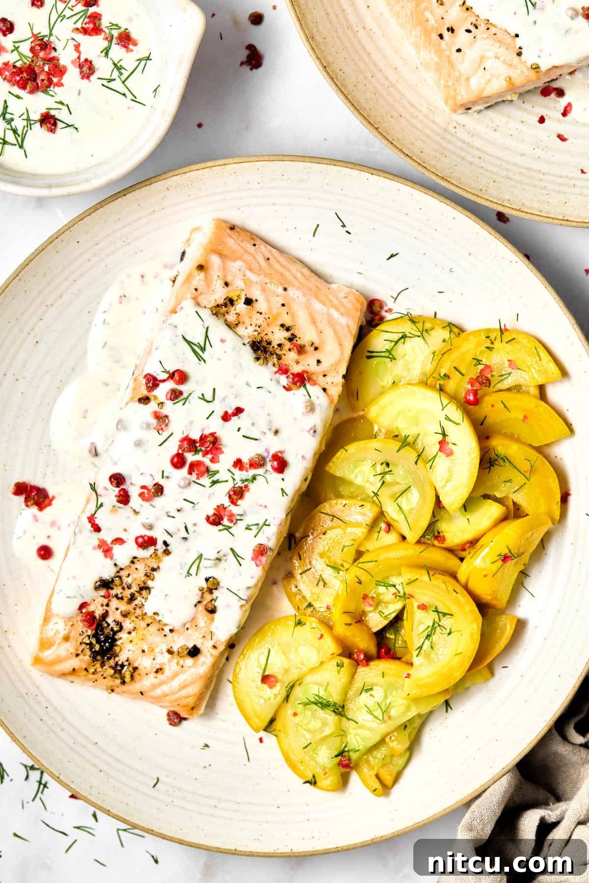 Roasted Salmon #ASpicyPerspective #Salmon #RoastedSalmon #OvenRoastedSalmon #RoastedSalmonRecipe #PeppercornSauce #PinkPeppercorn #PinkPeppercornSauce #MothersDay Plate with Oven Roasted Salmon with Pink Peppercorn Sauce with summer squash on the side.