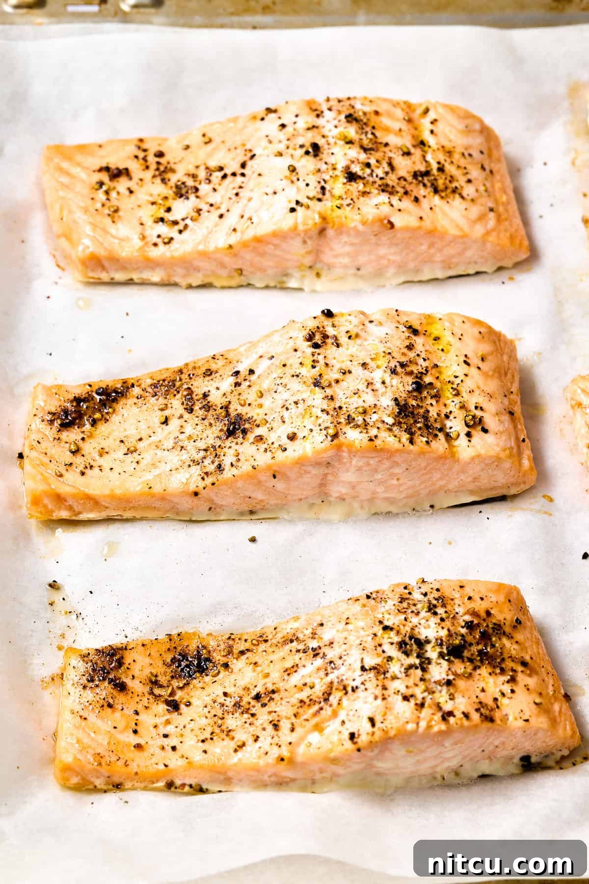 Peppercorn Sauce #ASpicyPerspective #Salmon #RoastedSalmon #OvenRoastedSalmon #RoastedSalmonRecipe #PeppercornSauce #PinkPeppercorn #PinkPeppercornSauce #MothersDay Roasted salmon on baking sheet - fresh out of the oven