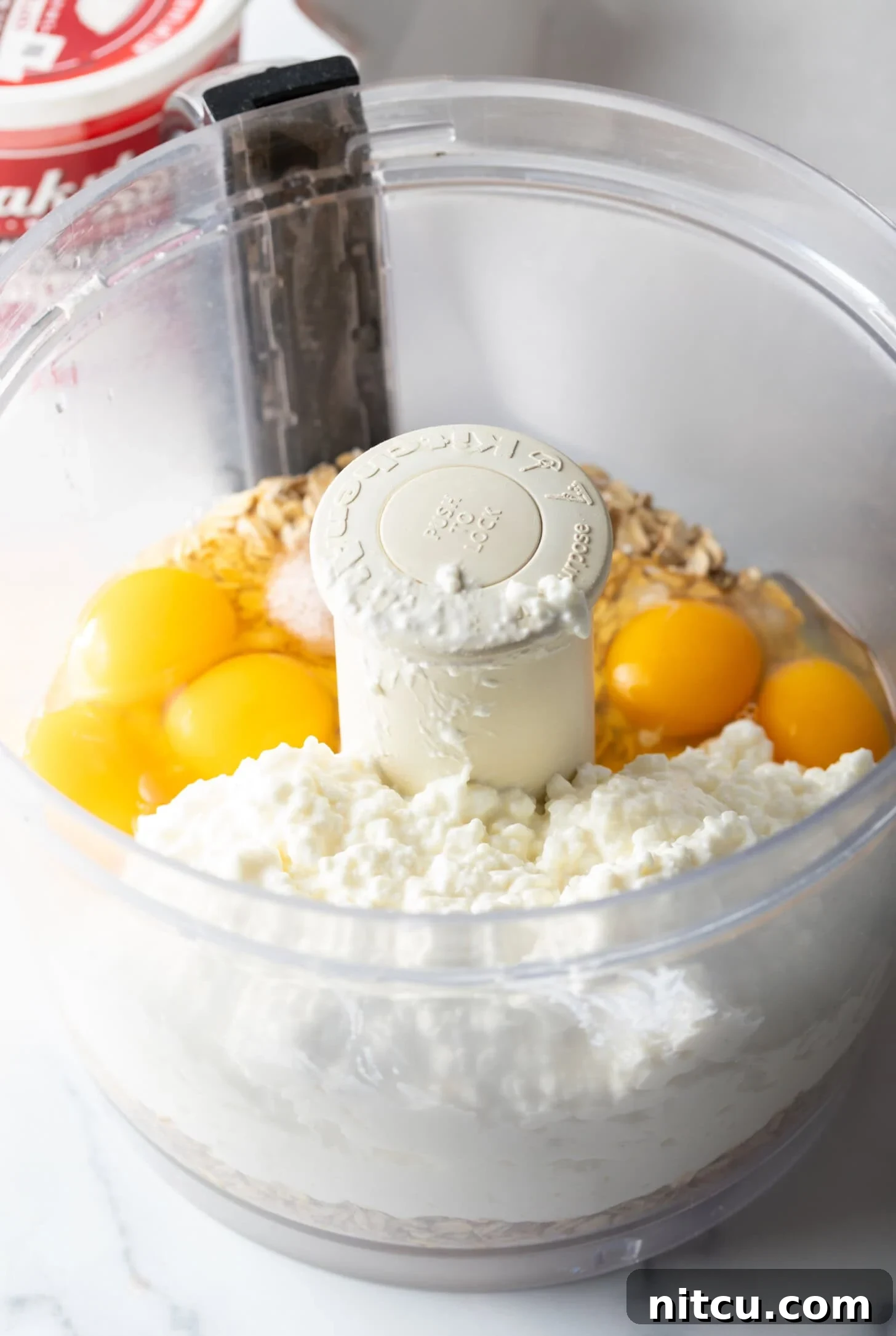 Eggs, cottage cheese, and oats in a food processor.