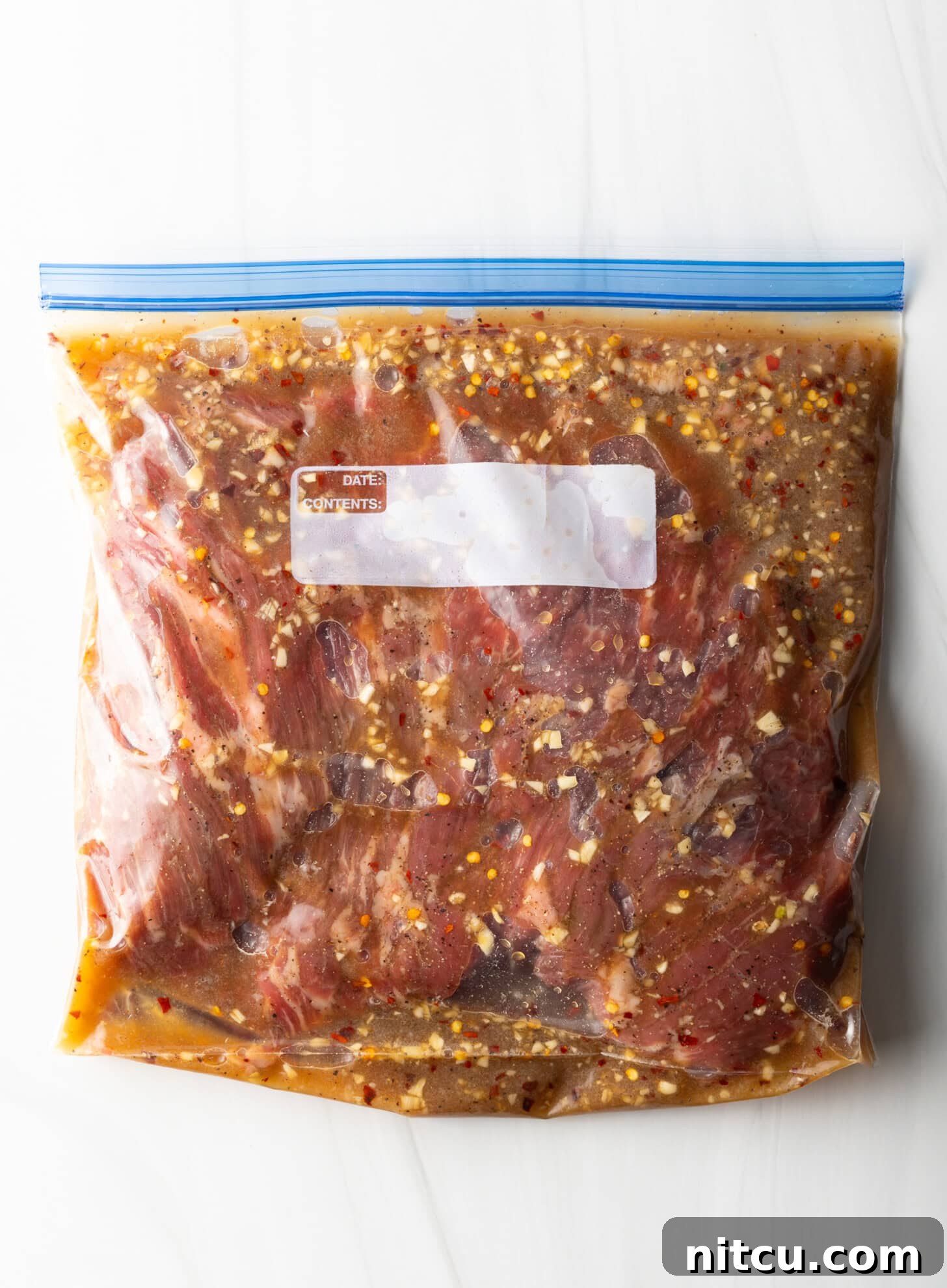 Thin Skirt Steak Delights 5 Raw meat in a ziploc bag with marinade.
