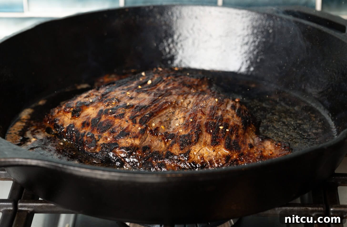 Thin Skirt Steak Delights 7 Searing a steak in a cast iron pan.