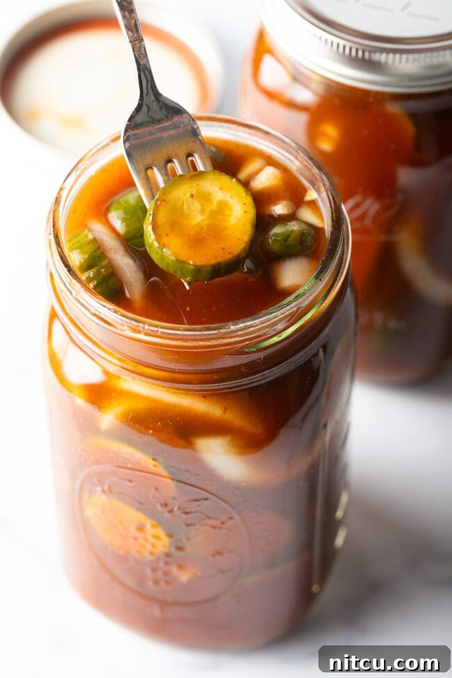 Chamoy Drenched Pickles 11 Fork pulling a chamoy pickle from the glass jar.