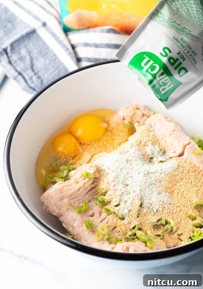 Adding ranch dressing powder mix to the bowl with other ingredients.