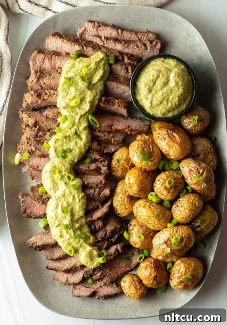 Strips of steak topped with creamy poblano sauce with a side of roasted baby potatoes.