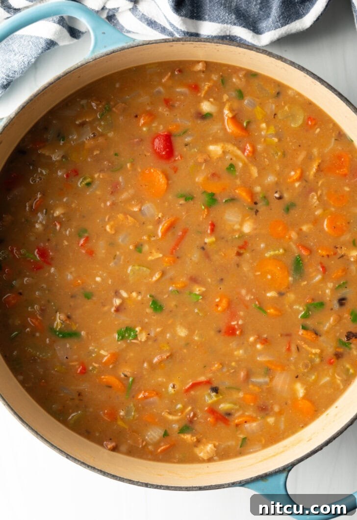 Top down view soup made with 15 beans and veggies in a large cooking pot.