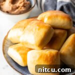 Stack of rectangle Texas Roadhouse rolls.