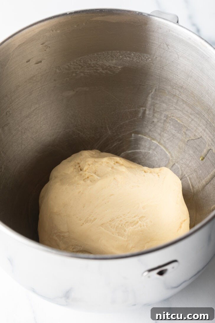 Dough in a metal bowl.