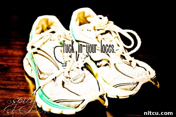 Running Tip: Tuck in Your Laces for Safety A runner's shoe with laces neatly tucked in to prevent tripping or discomfort.