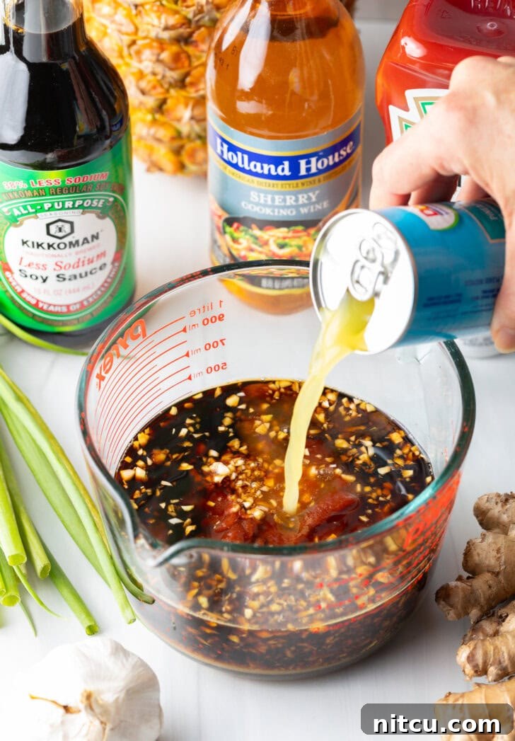 Tropical Glazed BBQ Chicken 6 Hand adding pineapple juice from a can into a huli huli chicken marinade in a large glass measuring cup, beginning the preparation.