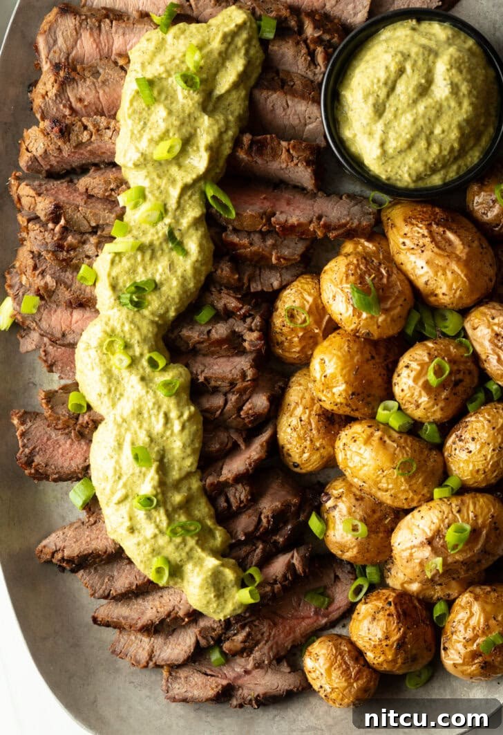 Signature London Broil Marinade 12 London broil sliced into thick strips, covered with rich green sauce and chopped scallions with baby potatoes on the side.