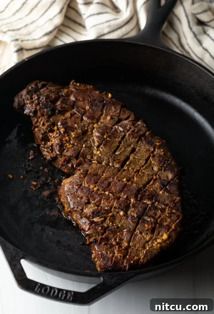 Signature London Broil Marinade 9 Searing the scored London broil is a large cast iron skillet.