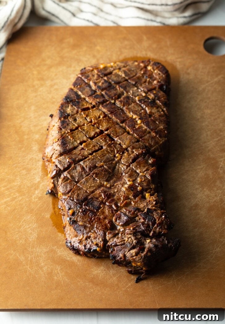 Signature London Broil Marinade 10 Seared London broil resting on a cutting board.