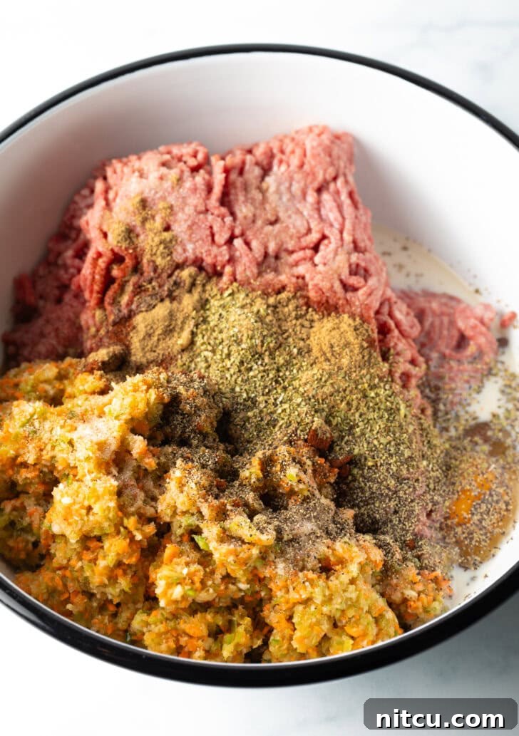 Pitmaster's Meatloaf 7 Close-up of the well-mixed meatloaf mixture in a bowl, showing its smooth and consistent texture before shaping.