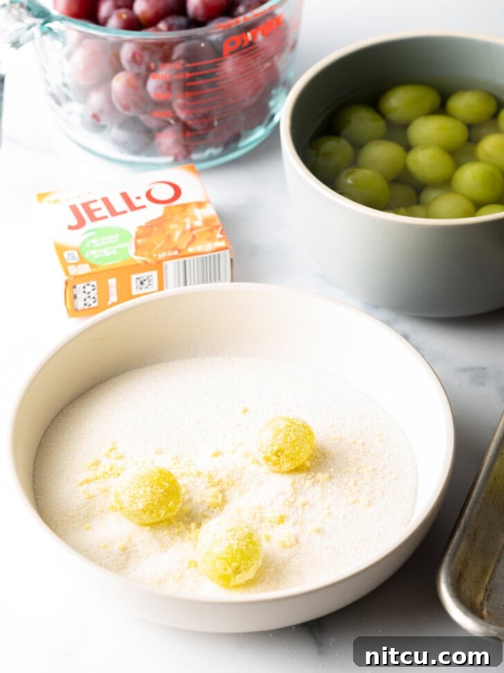 Sweet Grape Gems 7 Shallow bowl with 3 green grapes being rolled in a sugar and Jello powder mixture.