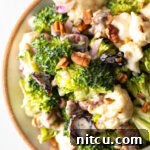 Top down view of broccoli and cauliflower salad in a large bowl